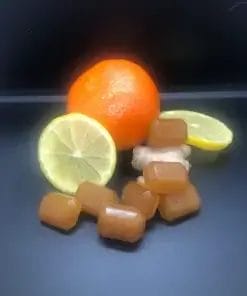Blood Orange & Lemon Ginger, Waar Botanicals CBD Gummies next to ginger, lemons and orange